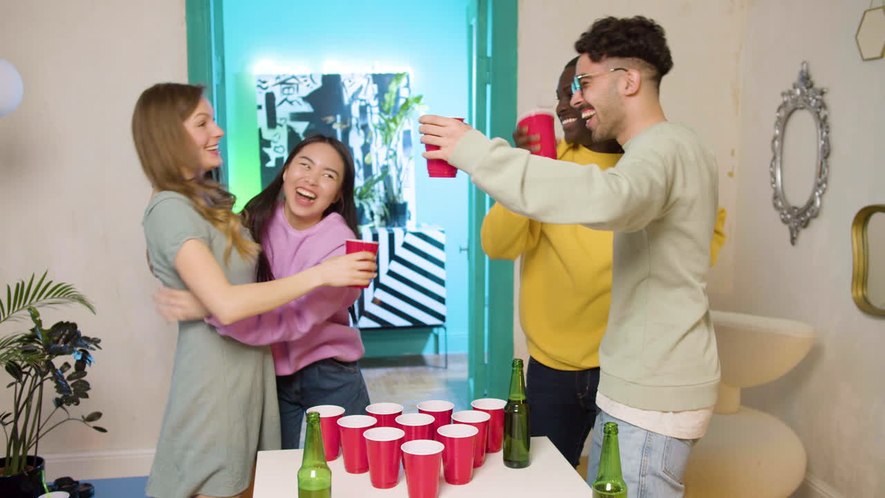 Free Stock Video - Multiethnic Young Friends Playing Beer Pong At Home