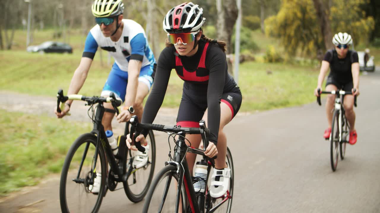 Free stock video - Group of focused athletes riding bikes