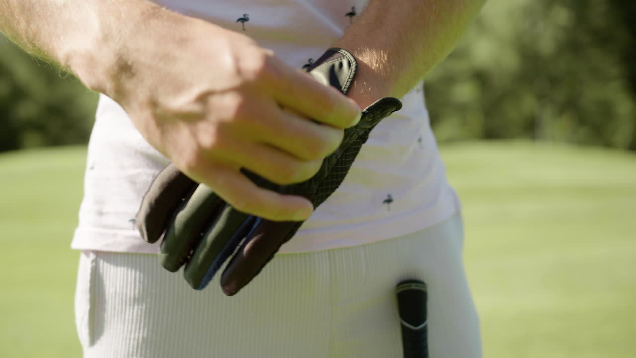 Free stock video - Man in flamingo-patterned shirt putting glove on to