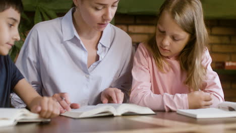 Young-teacher-and-students-reading-the-Bible-in-silence