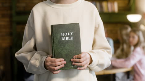 Closeup-of-girl-showing-Holy-Bible
