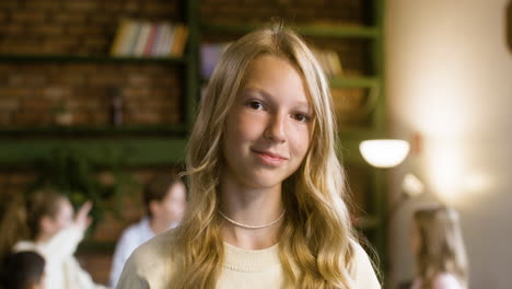 Closeup-of-blond-girl-smiling-at-the-school