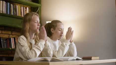 Christian-girls-praying-at-the-school