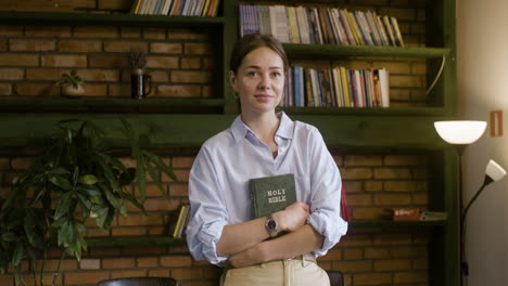 Young-brunette-woman-holding-Bible-book