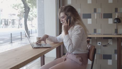 Positive-female-entrepreneur-talking-on-cellphone