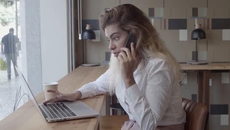 Happy-friendly-female-entrepreneur-talking-on-cellphone
