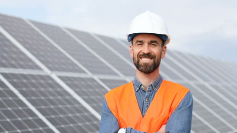 Portrait-of-young-male-engineer-with-helmet-near-solar-panels