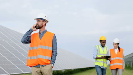 Chief-engineer-talking-on-the-phone-while-standing-on-solar-plantation