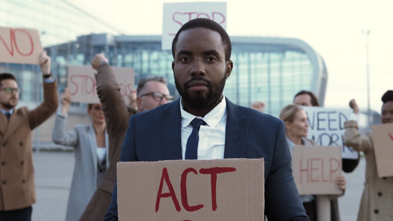 Free stock video Camera zoom out on an african american man holding