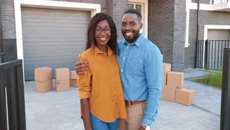 Dolly-shot-of-African-American-young-married-couple-of-man-and-woman-standing-at-new-home-when-moving-in