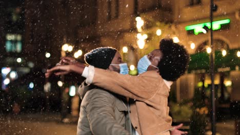 African-American-man-wearing-medical-mask-and-giving-xmas-gift-to-his-wife-on-new-year's-eve