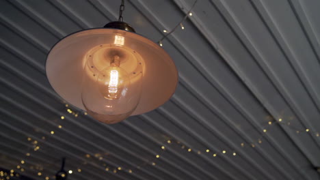 Old-electric-light-on-ceiling-with-fairy-lights