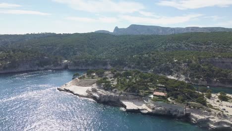 Aerial-drone-footage-flying-over-the-mediterrannean-sea-with-boats-and-beautiful-mountains-near-Marseille-1
