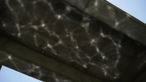 Water-reflection-on-concrete-bridge.-Arty-shot