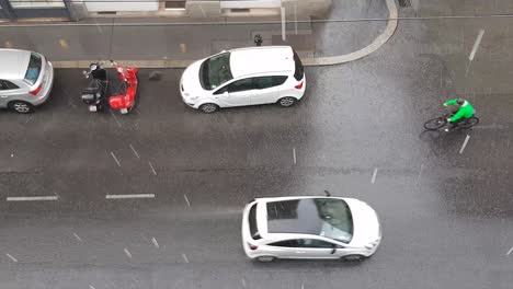 Top-down-view-on-road-with-cars-during-heavy-summer-rain
