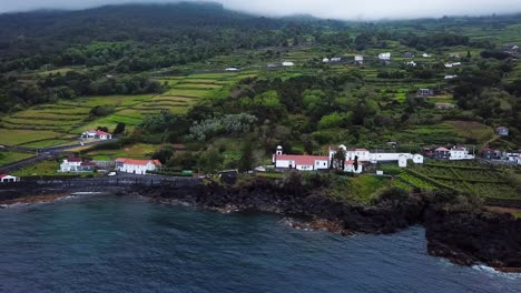 Wide-Aerial-Orbit-of-Manadas-and-Santa-Barbara-church-in-Sao-Jorge-island,-Azores