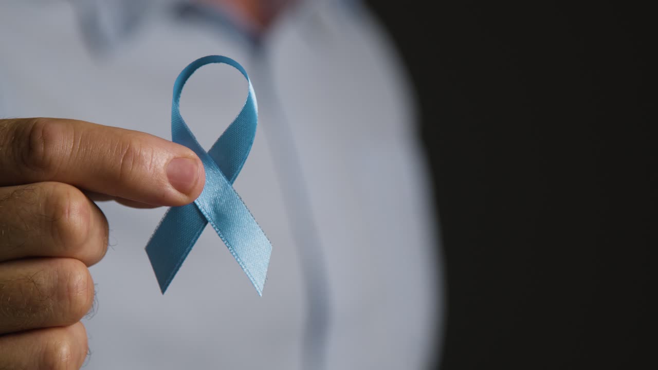 Free stock video - Close up of man holding blue ribbon badge ...