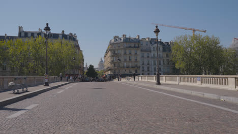 Female-Tourists-Standing-On-Bridge-Taking-Pictures-Of-Each-Other-In-Quais-De-Seine-District-Of-Paris-France