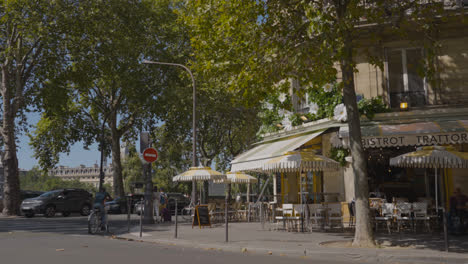 Typical-French-Bistro-In-Paris-France-With-Chairs-And-Table-On-Pavement