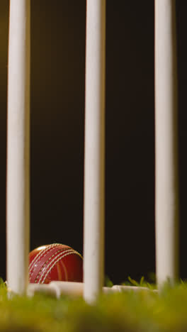 Vertical-Video-Cricket-Still-Life-With-Close-Up-Of-Ball-Hitting-Stumps-Bowling-Out-Batsman