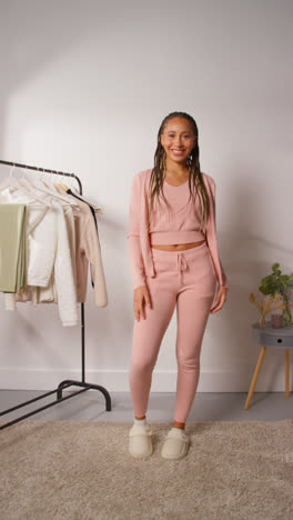 Vertical-Video-Of-Female-Social-Media-Influencer-Producing-User-Generated-Content-In-Studio-Trying-On-A-Variety-Of-Fashion-Outfits-Shot-In-Real-Time-3