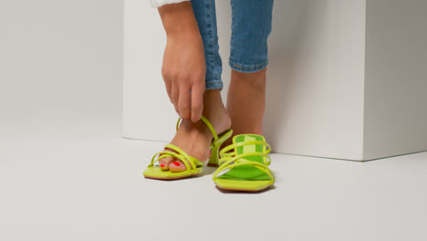 Close-Up-Of-Female-Social-Media-Influencer-Producing-User-Generated-Content-Putting-On-Beautiful-Pair-Of-Green-Shoes-4