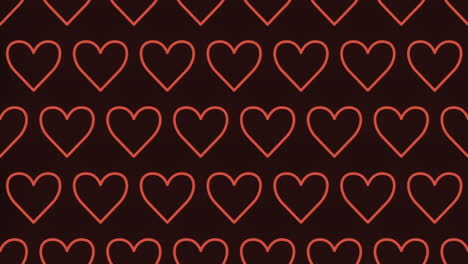 Glimmering-grid-of-red-hearts-illuminates-a-dark-background
