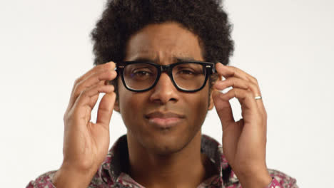 Close-up-Young-Man-Puts-Glasses-on