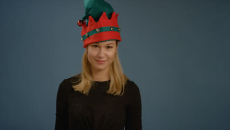Woman-Puts-on-Elf-Hat-and-Faces-Camera