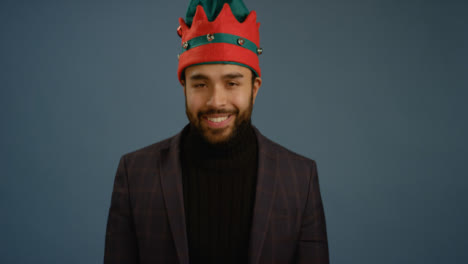 Young-Man-Puts-Elf-Hat-On-and-Smiles