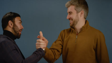 Two-Men-Celebrate-and-Shake-Hands