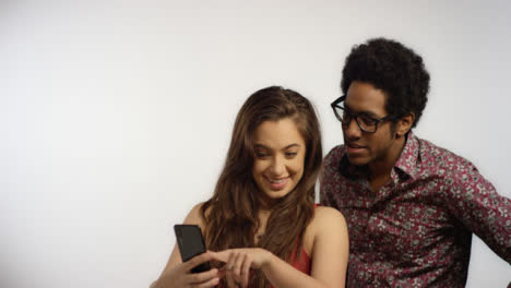 Couple-Look-at-Photos-on-Phone