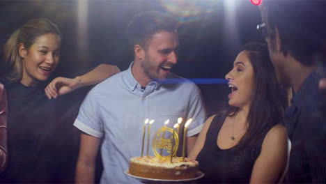 Man-Smiles-and-Blows-out-Birthday-Cake-Candles