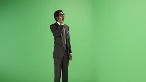 Businessman-receives-good-news-on-phone-with-green-screen