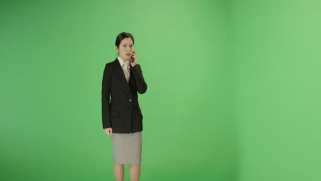 Serious-Businesswoman-answer-phone-on-green-screen