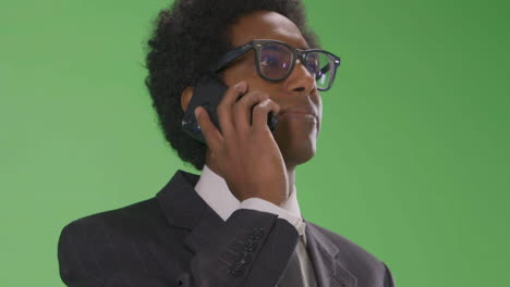 CU-Serious-Businesswoman-answer-phone-on-green-screen