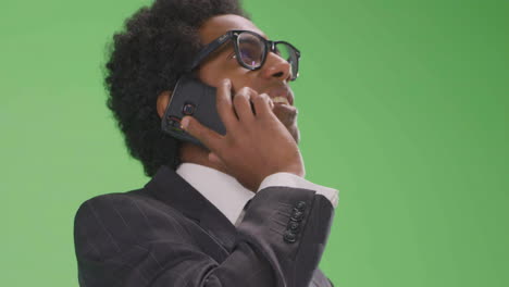 CU-Angry-Businessman-talking-on-phone-with-green-screen
