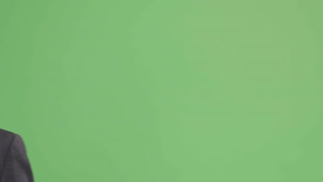 CU-Happy-Businessman-walking-and-talking-on-phone-with-green-screen