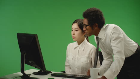 Businessman-Checking-on-Woman-at-Computer
