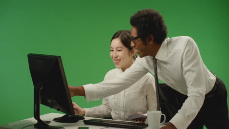 Happy-Businessman-Checking-on-Woman-at-Computer