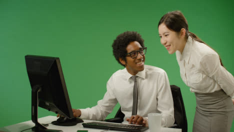 Happy-Business-Woman-Checking-on-Man-at-Computer