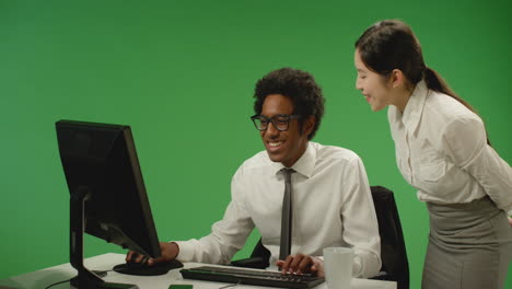 Happy-Business-Woman-Checking-on-Man-at-Computer
