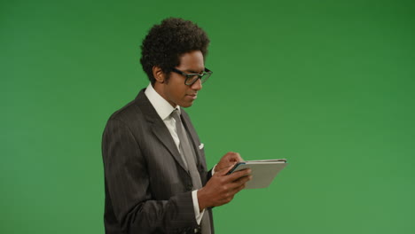 Annoyed-Businessman-Uses-Tablet-on-Green-Screen