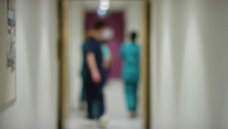 Blurred-Medical-Staff-In-Hospital-Corridor