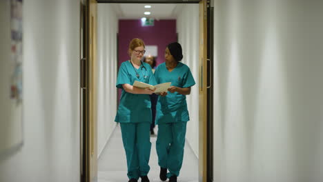 Two-Medical-Staff-Walk-Through-Corridor