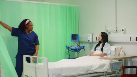 Nurse-Screening-Off-Hospital-Bed-With-Curtain
