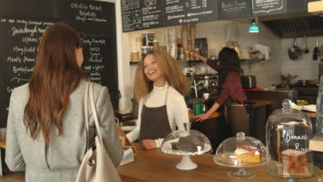 Woman-Walking-Up-to-Cafe-Counter