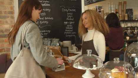 Woman-Paying-for-Coffee-Using-Smartphone