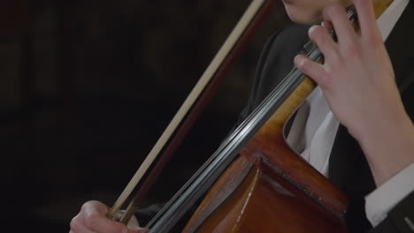 Tilt-Up-Close-Up-Male-Cellist-Performing