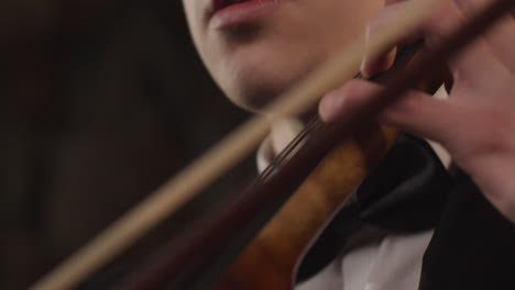 Side-View-Close-Up-Of-Male-Cellist-Plucking-Strings-On-Cello